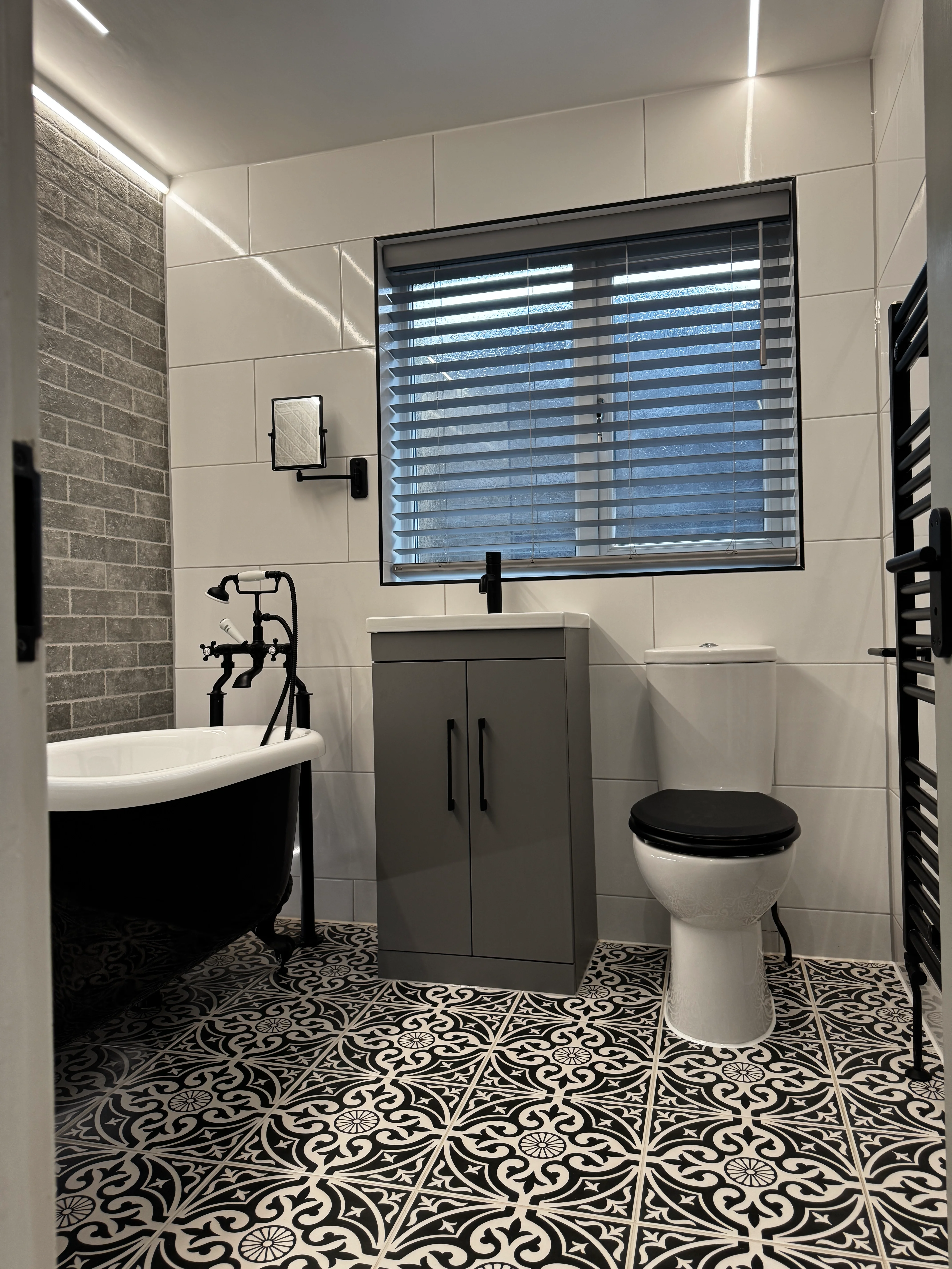 Bathroom LED feature lighting installed by Entigen in Kettering — close-up of the plaster-in profile and bath lighting