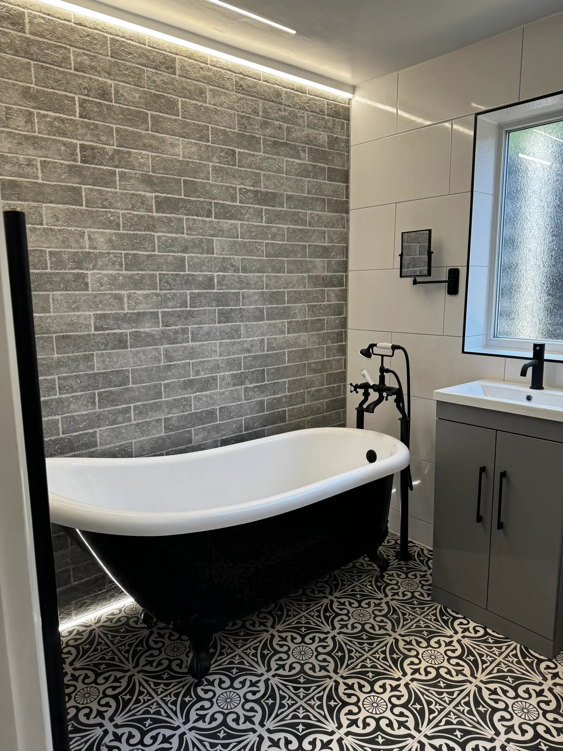 Luxury bathroom renovation with marble tiles and LED mirror