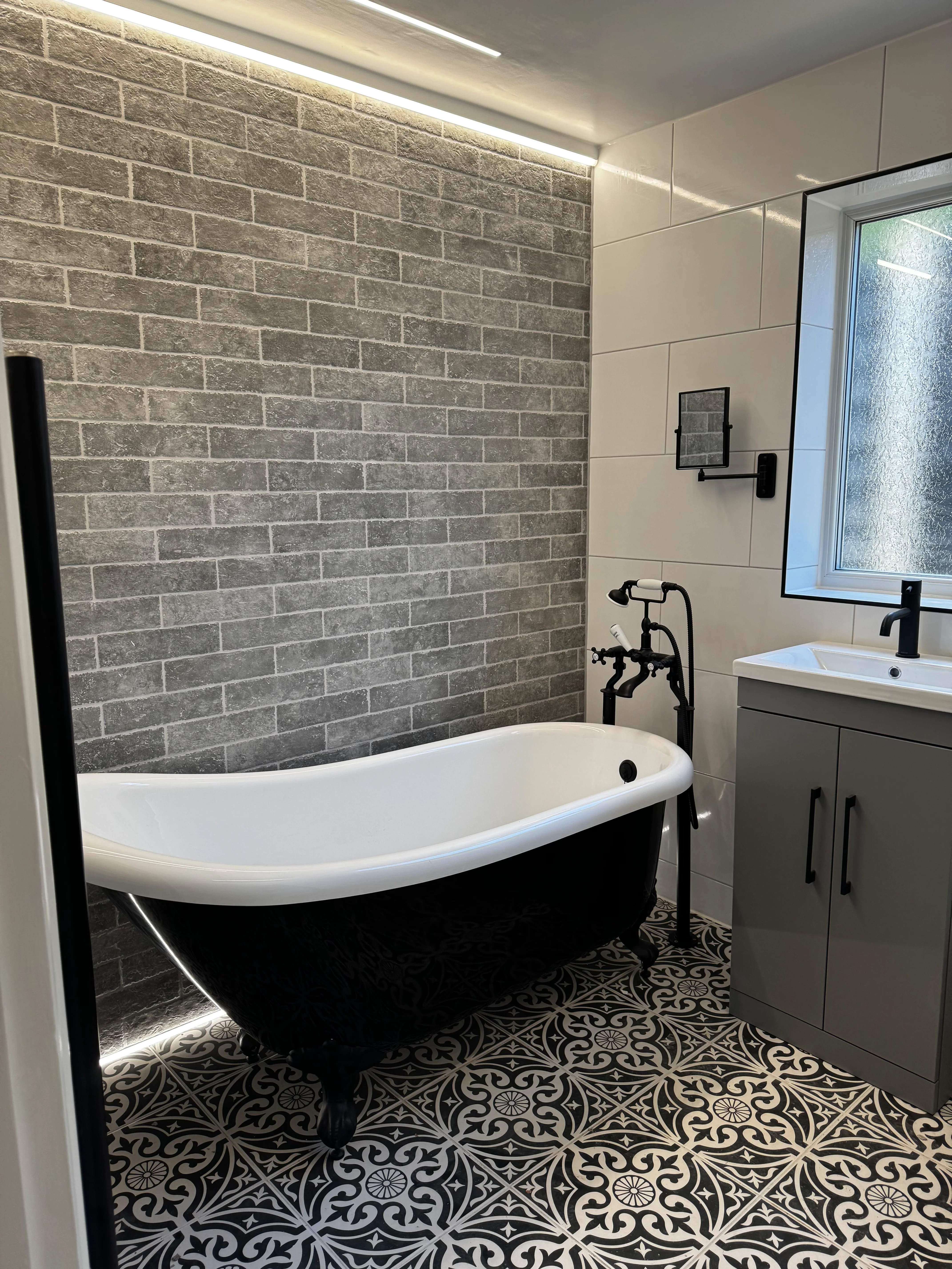 Luxury bathroom renovation with marble tiles and LED mirror